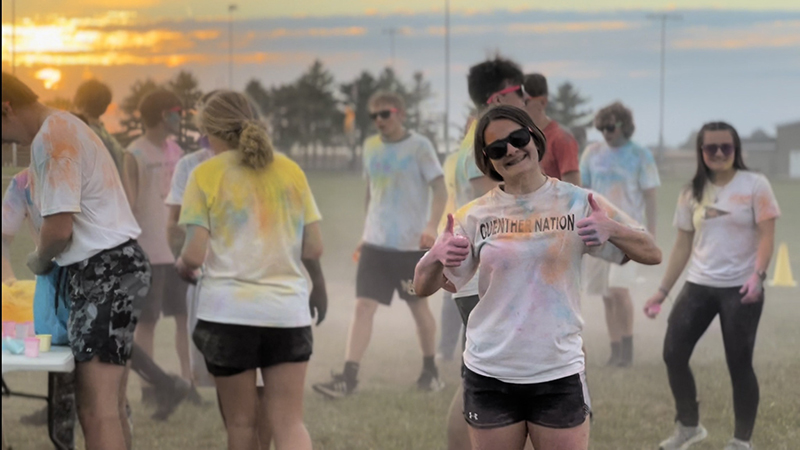 Students outside in tie-dye t-shirts during Homecoming activity